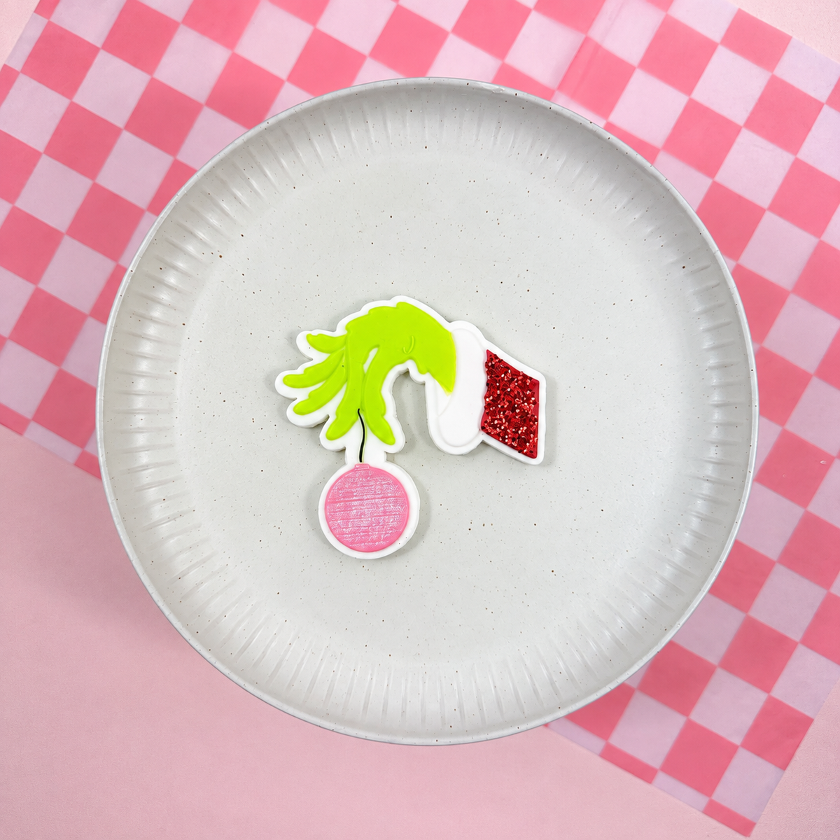 Grinch-Hand mit Christbaumkugel